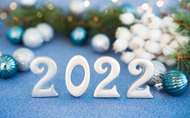 Happy New Years 2022. Christmas composition with number 2022, Christmas tree and New Year decorations. New Year concept. Close-up.