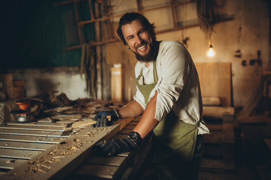 A male joiner works in the workshop. High quality photo