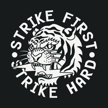 Black and White Traditional Tattoo Tiger with Lightning Illustration and Strike First Strike Hard Slogan Artwork on Black Background for Apparel and Other Uses