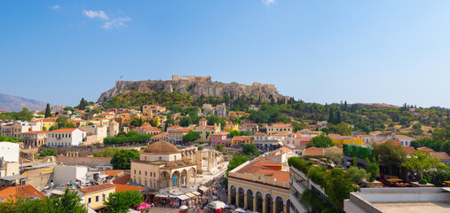 Aerial panoramic view of Monastiraki square and the ancient Parthenon on Acropolis hill in Athens, Greece.