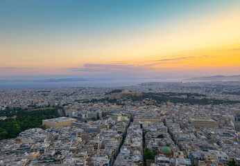 Fototapeta premium Evening sunset view from Lycabettus hill of the ancient Parthenon on Acropolis Hill in central Athens, Greece