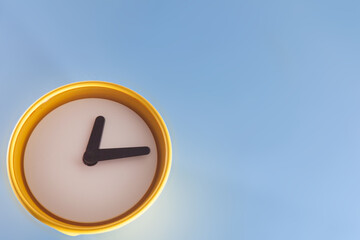 Yellow round clock with. Minimalist flat lay image of plasticl clock over blue background with copy space. Close-up