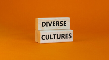Time to diverse cultures symbol. Wooden blocks with words 'Diverse cultures'. Beautiful orange background. Business and diverse cultures concept. Copy space.