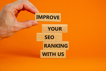 Improve your SEO ranking with us symbol. Wooden blocks with words Improve your SEO ranking with us. Businessman hand. Beautiful orange background, copy space. Business, improve SEO ranking concept.