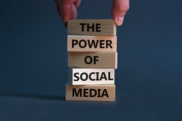 Power of social media symbol. Wooden blocks with words The power of social media. Businessman hand....