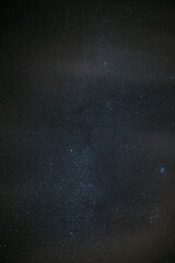 Milky Way Galaxy Glowing Through The Light Cloudiness Overcast. Real Night Sky Stars. Natural Starry Sky Dark Black Background Backdrop