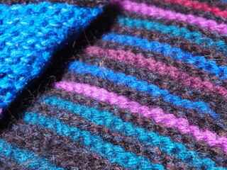 Bright blue and violet crochet stitch background.  Wool knitted texture. Knitted wool blanket