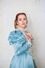 Beautiful young woman in medieval style blue dress