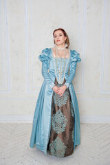 Beautiful young woman in medieval style blue dress