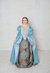 Beautiful young woman in medieval style blue dress