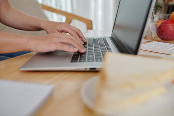 Close-up image of businesswoman workng at home office, coding or answering e-mails