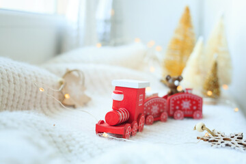 Red wooden toy train. Happy holidays, greeting card, Christmas mood concept. Copying a close-up space