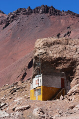  Cement cabin builded under the ledge of a rock in the Andes Mountains on the old border route between Argentina and Chile. "Funes" Legend  it&acute;'s a last name writed by a tourist. Isn't a propety