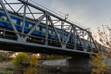 railroad and railway bridge and a passing passenger train