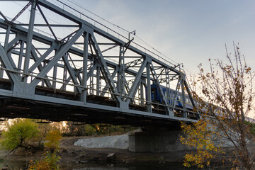railroad and railway bridge and a passing passenger train