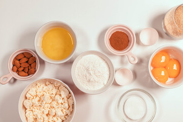 Baking cooking ingredients flour eggs with butter on a bright white background. Mockup of a pie or cake with cookies recipe