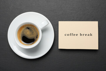 Cup of hot espresso and card on black background, flat lay. Coffee break