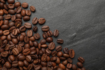 Aromatic coffee beans on black table, flat lay. Space for text