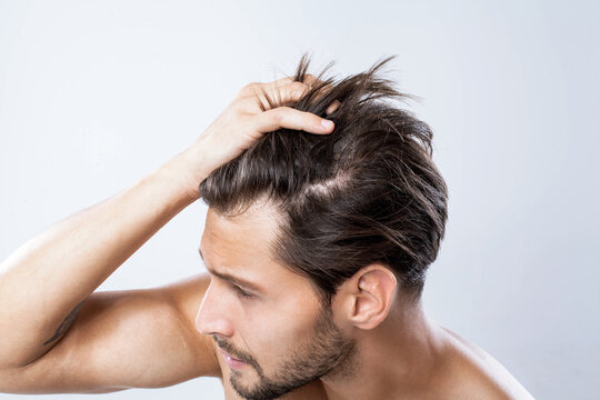 Man Touching His Hair With One Hand