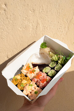 Sushi Maki Roll In Takeout Paper Box. Young Woman Holding Box With Food. Summer, Healthy Eating Outside. KETO, Low-carb Gunkan Set With No Rice. Japanese Takeaway Restaurant, Fast Food Delivery