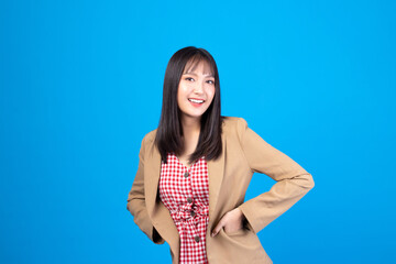 Portrait of beautiful young Asian girl model long hair in casual summer clothes smile, happy and enjoying in studio isolated on blue background.