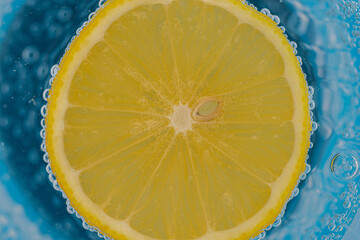 A slice of lemon in carbonized water with bubbles