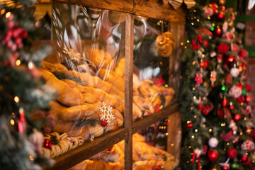 Old bakery window on christmas eve. Freshly baked bread and rolls are sold in bakery window. Showcase with traditional french pastries. Bread on showcase in supermarket