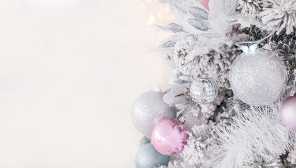 Fototapeta na wymiar new year pink, silver and turquoise Christmas decorations with balls and bows on the background of Christmas lights. Light background. White, gray. Background for postcards