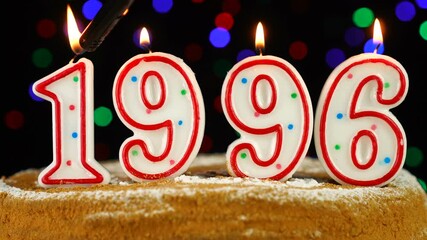 Birthday cake with white burning candles in the form of number 1996