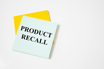 Product Recall text written on a white notepad with colored pencils and a yellow background. word