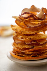 Close up dried fruits stack, pineapple and apples slices on bright background. Vegan, healthy snack or dessert