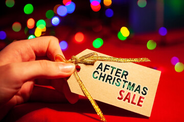 A woman's hand holds a label with text.