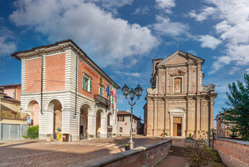 Fototapeta na wymiar Moretta, Cuneo, Italy - the town hall and parish church of San Giovanni Battista (XVIII century) in Piazza Umberto I
