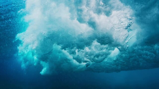 Wave rolls and breaks. Ocean wave rolls and breaks over the flat reef bottom in Maldives