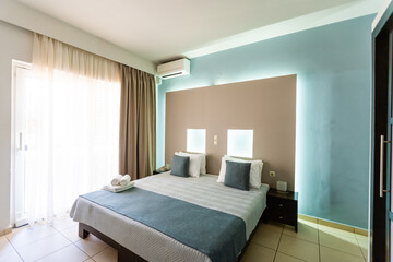 Big comfortable double bed in elegant classic bedroom