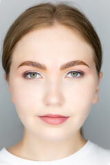 the face of the blonde model and the finished procedure lamination of eyebrows eyebrows combed with...