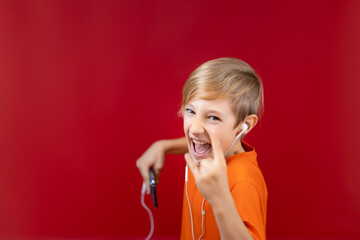 boy rocker shouts and listens to music, heavy metals shows heavy metal gestures