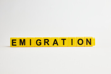 The word emigration consists of individual cubes with letters.