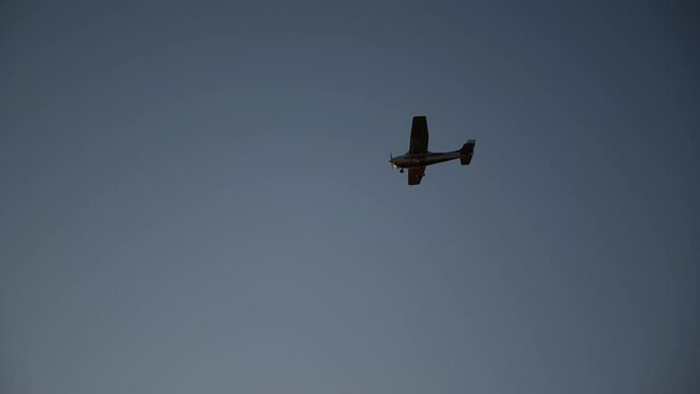 a small plane is flying into the sunset