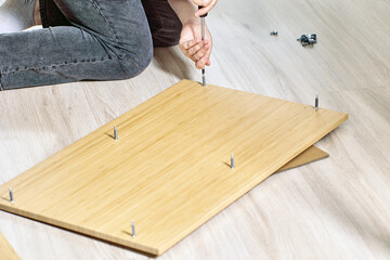 Fastening dowels in sockets when flat pack furniture assembly.