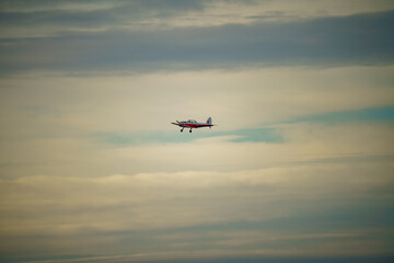 Fototapeta na wymiar 1951 DHC-1 Chipmunk WD363 22 C-N C1-0304 flies low overhead in a blue and grey cloud winter sky