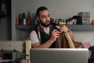 Middle eastern man teaching sewing courses online.