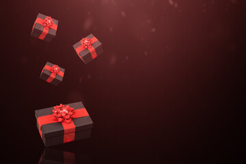 Black gift boxes with red bow on the black background.