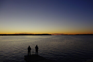 Fototapeta premium silhouette of a person on a pier