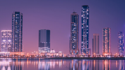 Plakat The tallest towers in the Emirates and their reflection on the lakes at night, Dubai, Sharjah