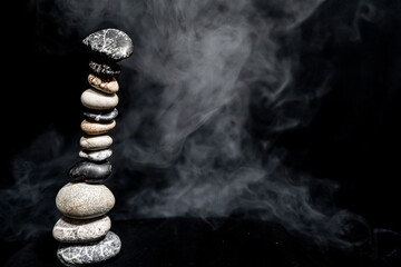 Stone tower.Smoke. Abstract spirituality of zen stones relaxation.