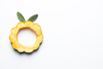 Sliced acorn squash with lambs ear leaves isolated on a white background.