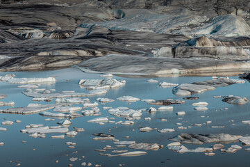 Detail or a close up of a glacier in iceland at Hoffell. Huge glacier on a s unny day, Visible chunks of ice and water.