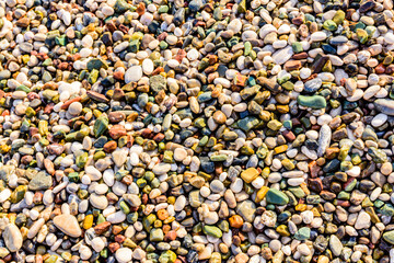Texture of pebbles at the seaside. Natural background