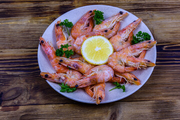 Shrimps with lemon and parsley on a plate